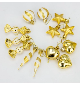 Flat lay of 13 gold and white Christmas ornaments including stars, hearts and candy shapes