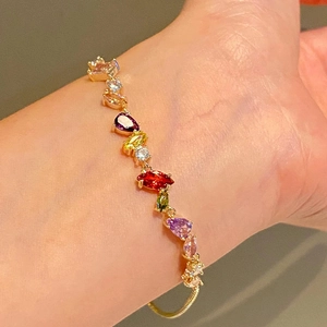 18k gold plated bracelet with colorful cubic zirconia stones worn on a female wrist