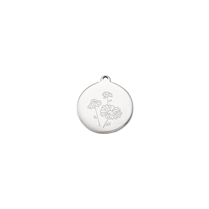 Detailed macro view of silver stainless steel round pendant with daisy flower engraving