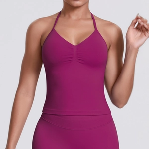 Detail of high-stretch berry-colored sports bra set with halter neck and ribbed texture