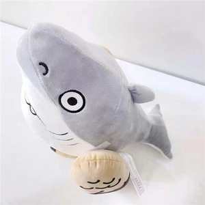 Plush shark doll in gray and white with boxing gloves on a white background