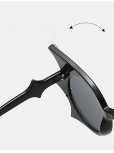 Detail shot of durable metal hinges on oversized butterfly bat sunglasses with gray lenses