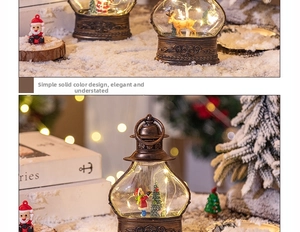 Close-up of vintage bronze LED lantern with Santa Claus and reindeer miniature scene