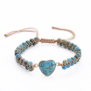Detail of handmade woven bracelet with heart-shaped turquoise stone and adjustable cord
