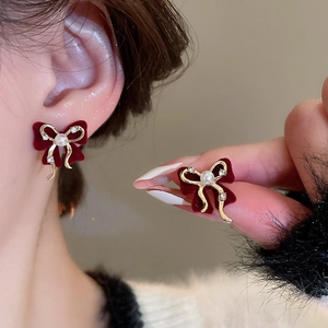 Detail showing red flocked bow earrings with pearl and rhinestones for a sweet look