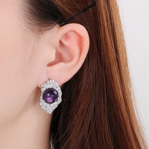 Detail of vintage geometric titanium steel earring with purple opal on silver base