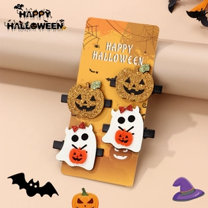 Detail of Halloween hair clip set featuring glitter pumpkins and ghosts on display card