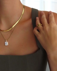 Detail showing 18K gold layered chain necklaces and matching chain style ring on model