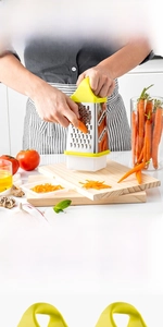 Detail of 4-sided stainless steel grater with ergonomic yellow handle and storage base