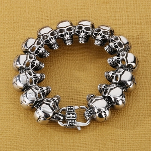 Detailed top view of retro silver skull bracelet with intricate punk rock engravings