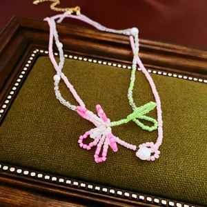 Handmade beaded necklace set with pink and green floral design and pearl accents
