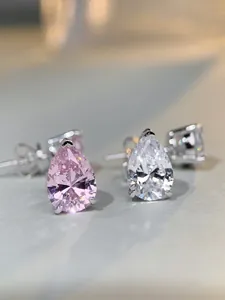 Macro shot of pear-cut pink and white 5A carbon diamond earrings with 3-claw silver setting