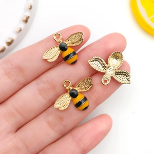Detailed view of yellow and black enamel bee alloy charm with gold plating for DIY jewelry