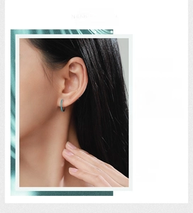 Detail of S925 sterling silver hoop earrings with blue turquoise stones on model