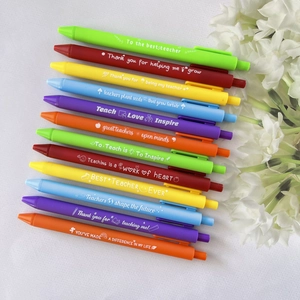 Macro view of 12 colorful retractable pens with teacher appreciation slogans on white background