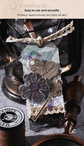 Close-up of vintage DIY scrapbooking materials with heart tags and bronze keys
