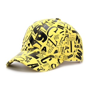 Detail of a bright yellow baseball cap featuring black letter prints and twill canvas texture