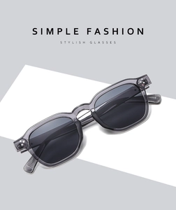 Detail view of transparent grey square sunglasses with stylish rivets and dark lenses