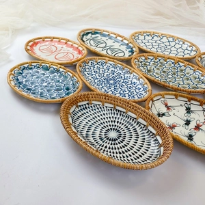Handcrafted ceramic fruit basket with woven rattan edge and hand-painted fish patterns