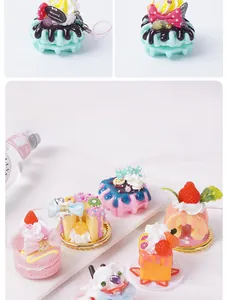 Macro shot of realistic PVC cupcake and macaron charms with detailed cream and strawberry