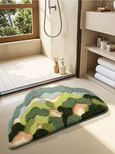 Detailed close-up of mountain-shaped plush bath mat with 3D tufted green fibers