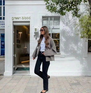 Detailed street style shot of a grey oversized double-breasted blazer for women