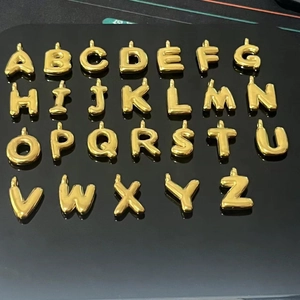 Golden 3D bubble initial pendants A to Z in stainless steel on black background