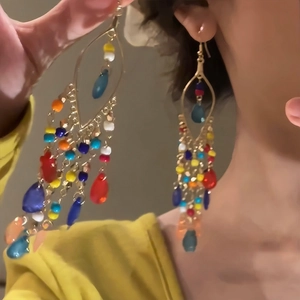 Bohemian teardrop earrings featuring colorful beads and tassels in vibrant gold finish