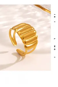 Macro shot of 18K gold plated ripple ring with polished textured surface and open band