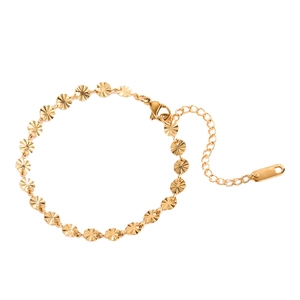 Elegant gold titanium steel bracelet featuring minimalist embossed circular charms on white background