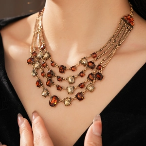 Detail of vintage bronze multi-layered necklace with amber and champagne stones