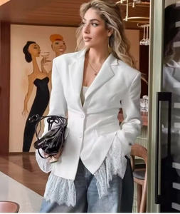 Detail of white blazer featuring elegant lace cuffs and hem stitching for women