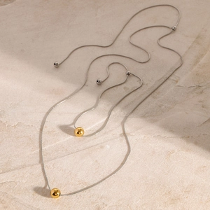 Minimalist two-tone stainless steel snake chain necklace with gold ball pendant
