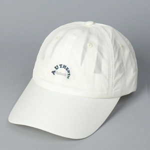 Close-up of white quick-dry baseball cap featuring detailed AUTHENTIC navy embroidery