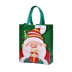 Large green Christmas gift bag featuring a cartoon Santa Claus and a sturdy handle