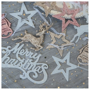 Detailed view of Christmas glitter ornaments featuring stars, elk, and bells in festive colors