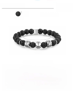 Detail of 8mm black lava stone beads and customizable stainless steel charms on a men's bracelet