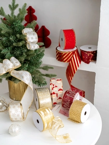 Close-up of festive Christmas ribbons with snowflake prints and glittery stripe patterns