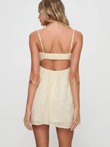 Women's backless lace mini dress in light yellow with bow tie and embroidery details