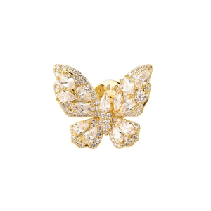 Detail of a golden butterfly brooch with white crystals and sparkling water-drop stones