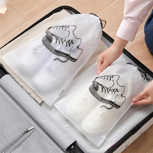 Frosted translucent drawstring shoe storage bags with sneaker print inside a suitcase