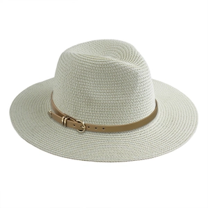 Detailed close-up of woven paper straw texture with brown leather belt and gold buckle