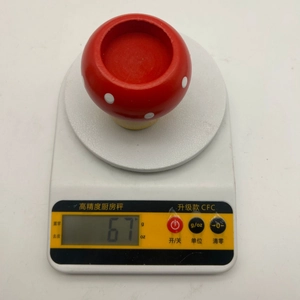 Detailed view of mushroom candle holder weighing 6.7g on high precision digital scale