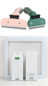 Detail of pink and green pet deshedding combs with ergonomic non-slip rubber handles