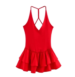 Detail of red sleeveless halter dress featuring deep V-neck and ruffled layered hem