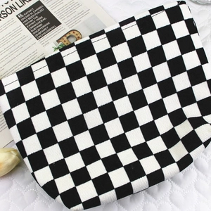 Corduroy checkered makeup bag with black and white grid pattern on quilted fabric