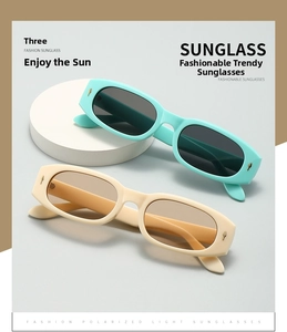 Detail view of rectangular sunglasses showing metallic diamond accents on the frame temples