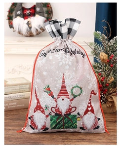 Close-up of linen Christmas gift bag with festive gnome illustration and drawstring