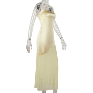 Detail view of light yellow satin camisole dress with elegant flowing fabric on a mannequin