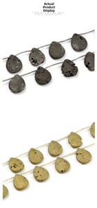 Macro detail of porous water-drop lava stone beads in matte grey and metallic gold